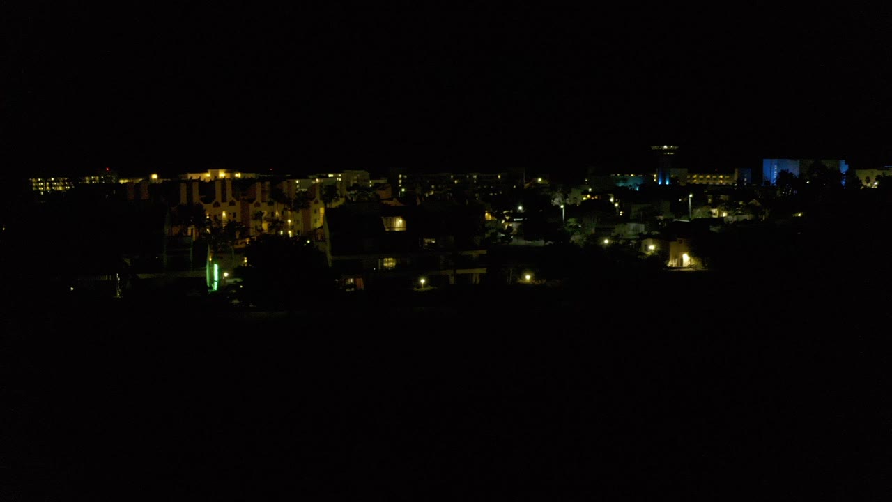 Dark night skyline with scattered colored lights