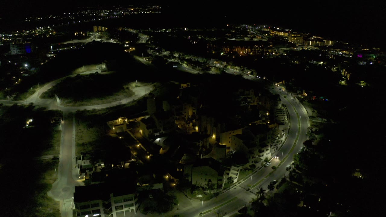 Night aerial view of lit roads and residential buildings