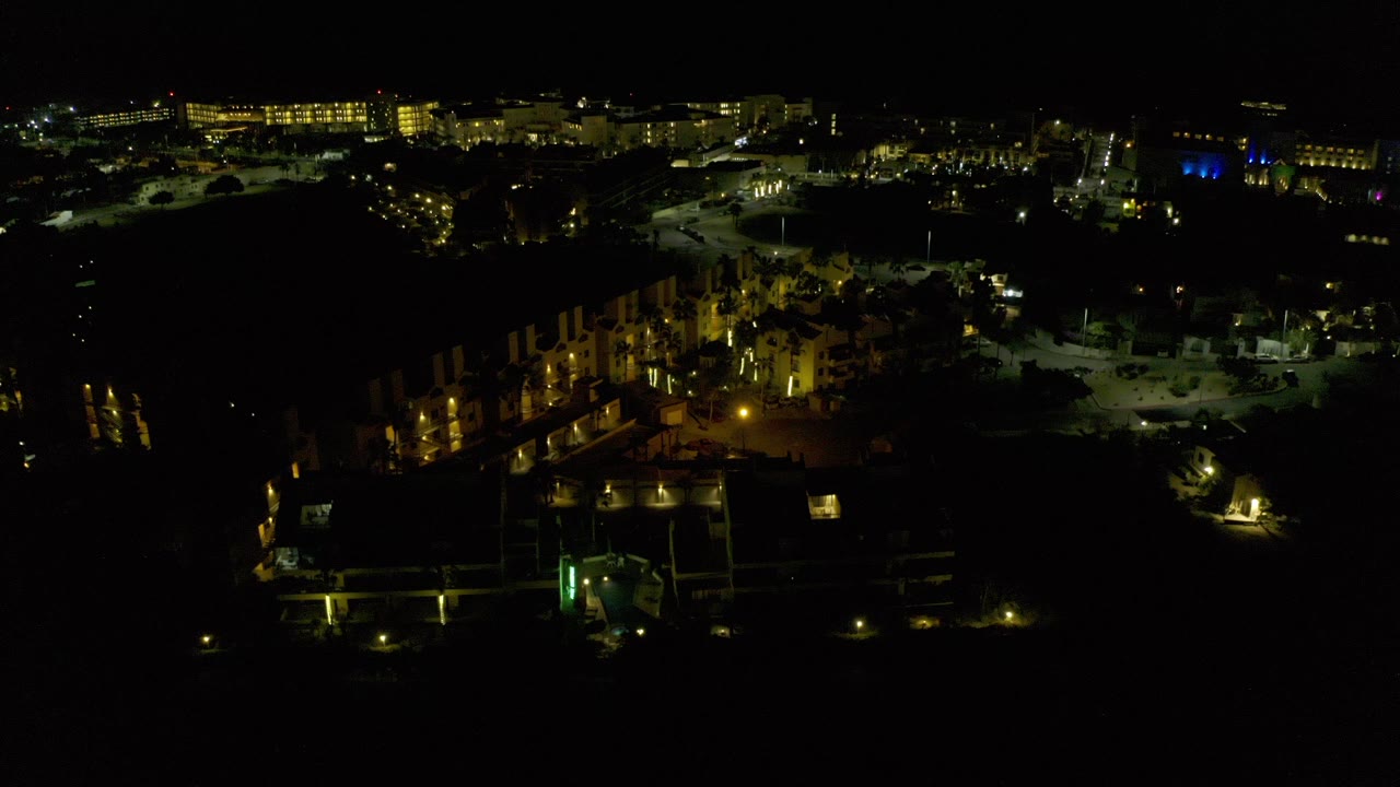Dark aerial view of illuminated buildings at night