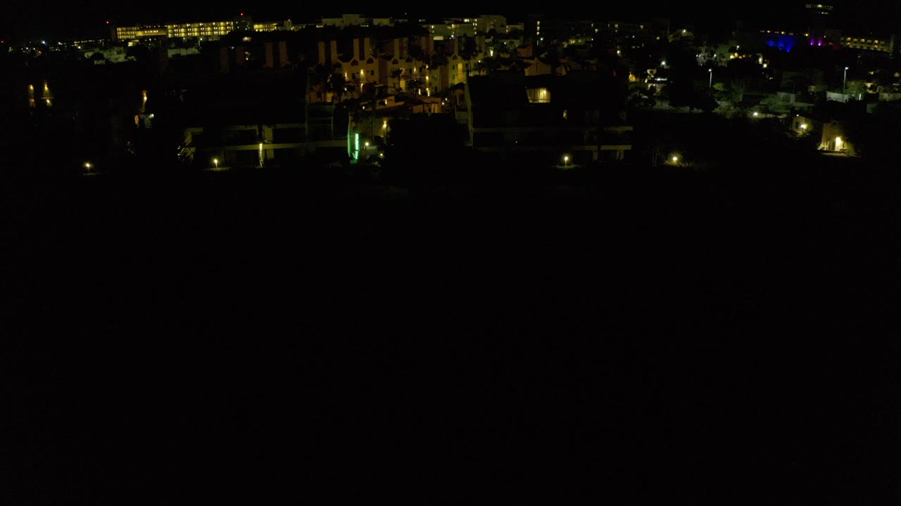 Dark aerial view of city lights at night