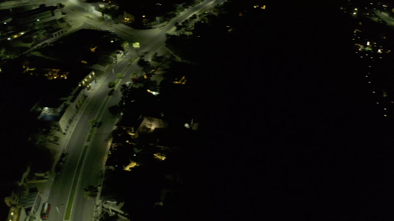 Night aerial road scene with a small vehicle shape