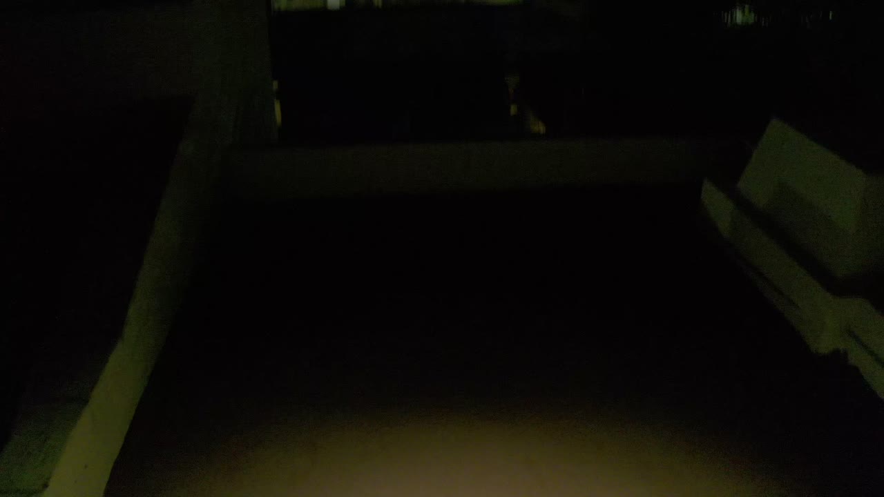 Dim rooftop corner under greenish night exposure