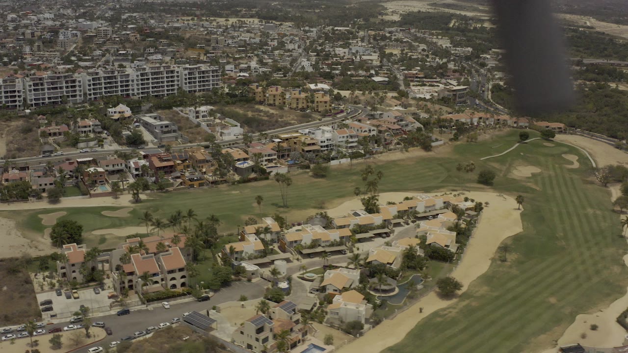 Aerial view of homes, apartment buildings, and a golf course.