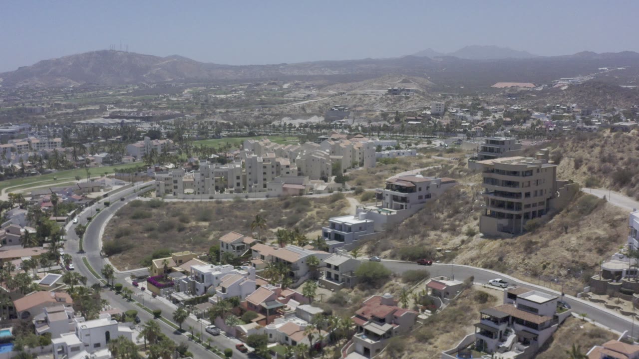 Hillside neighborhood with roads and low-rise buildings