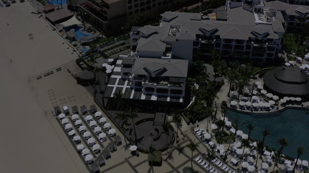 Overhead resort complex with beach loungers and pool visible