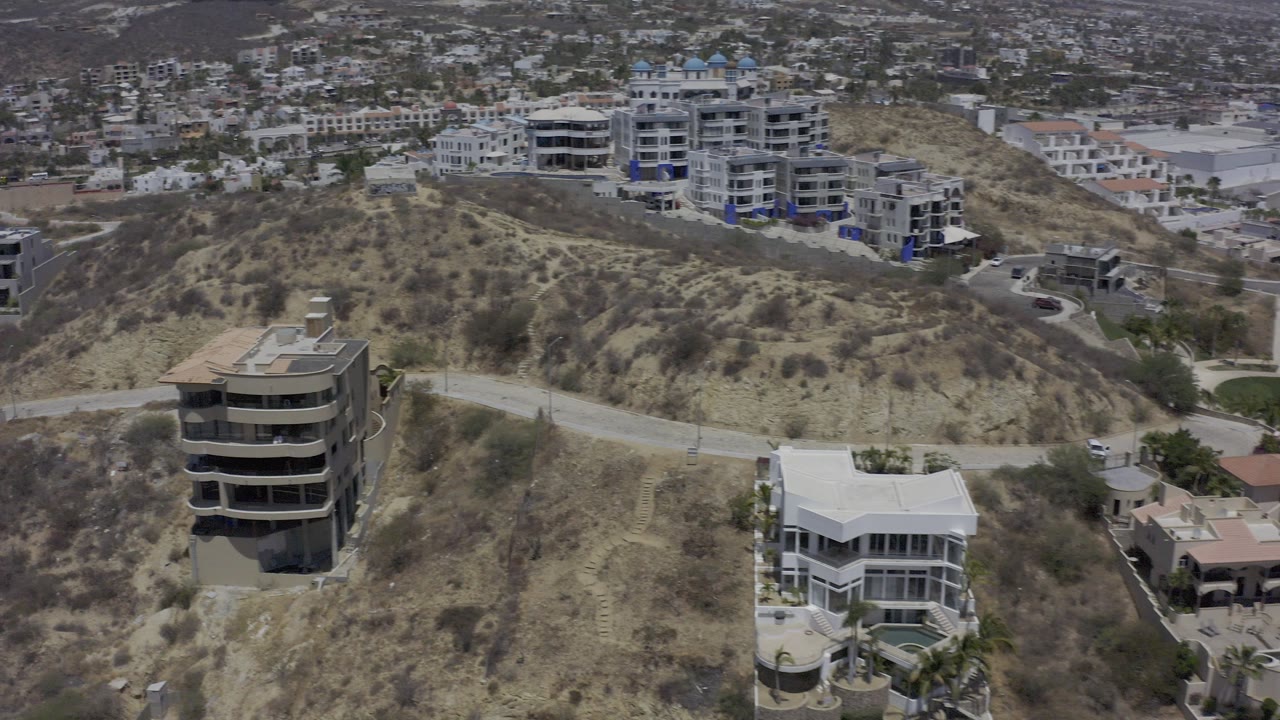Aerial view of hillside homes and dry terrain