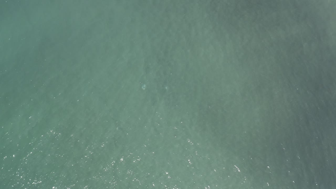 Muted turquoise water with soft ripples