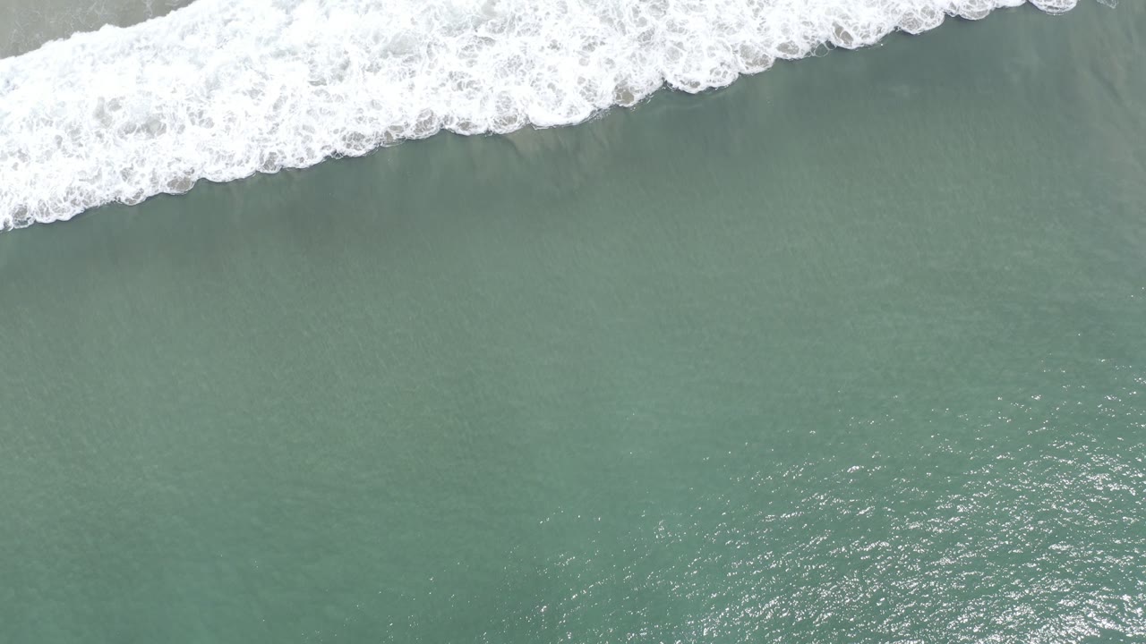 Overhead surf line crossing green ocean water