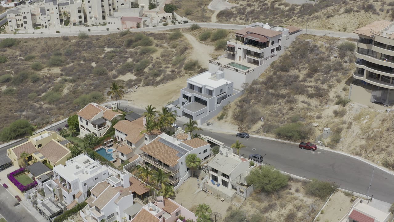 Aerial view of homes below hillside buildings