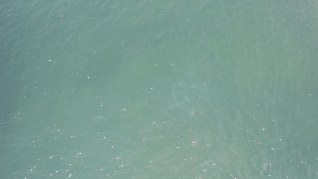 Pale green water with subtle wave patterns