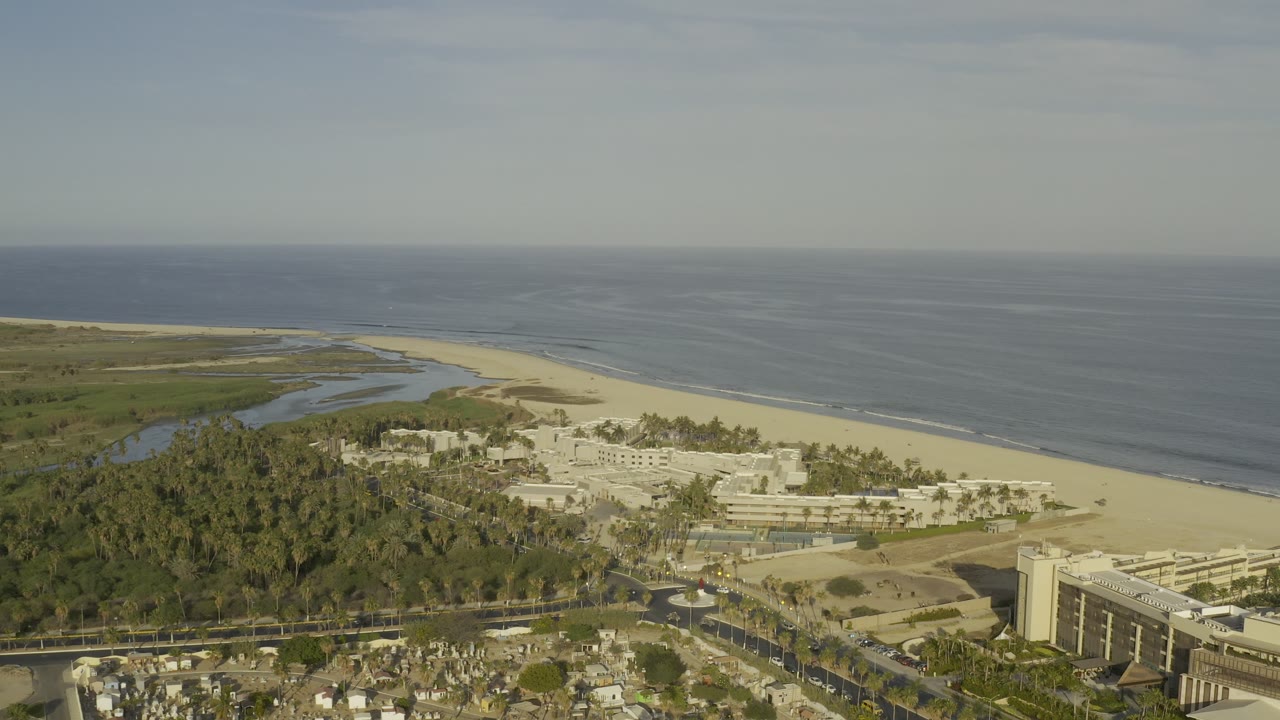 Coastal aerial view with lagoon, beach, ocean, and hotel buildings