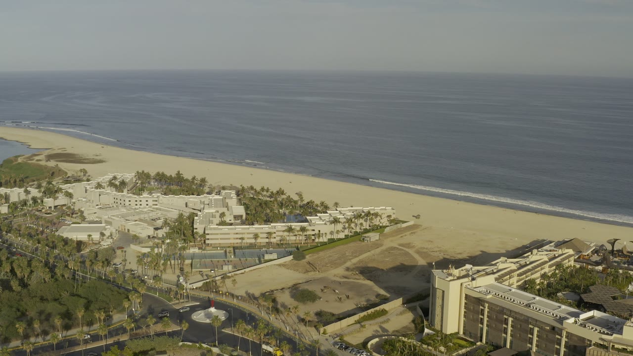 Drone-like view of Los Cabos beach area and nearby roads.