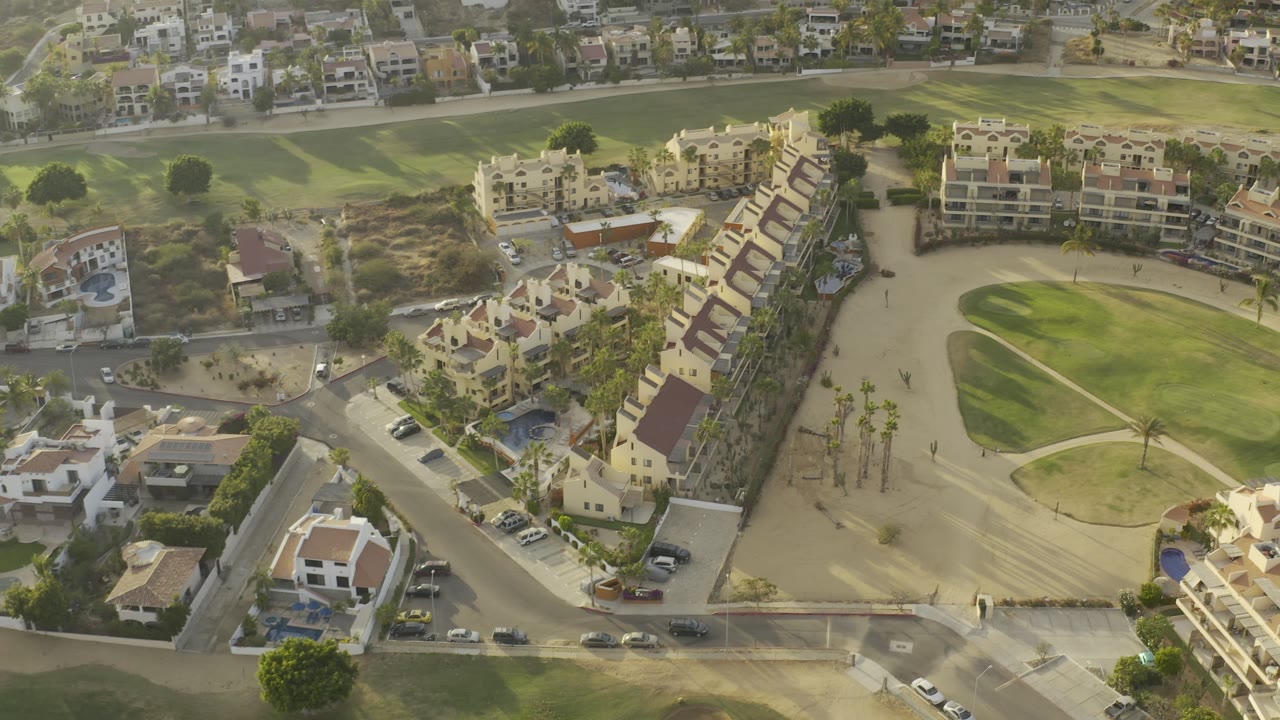 High angle over apartment buildings and golf-course paths