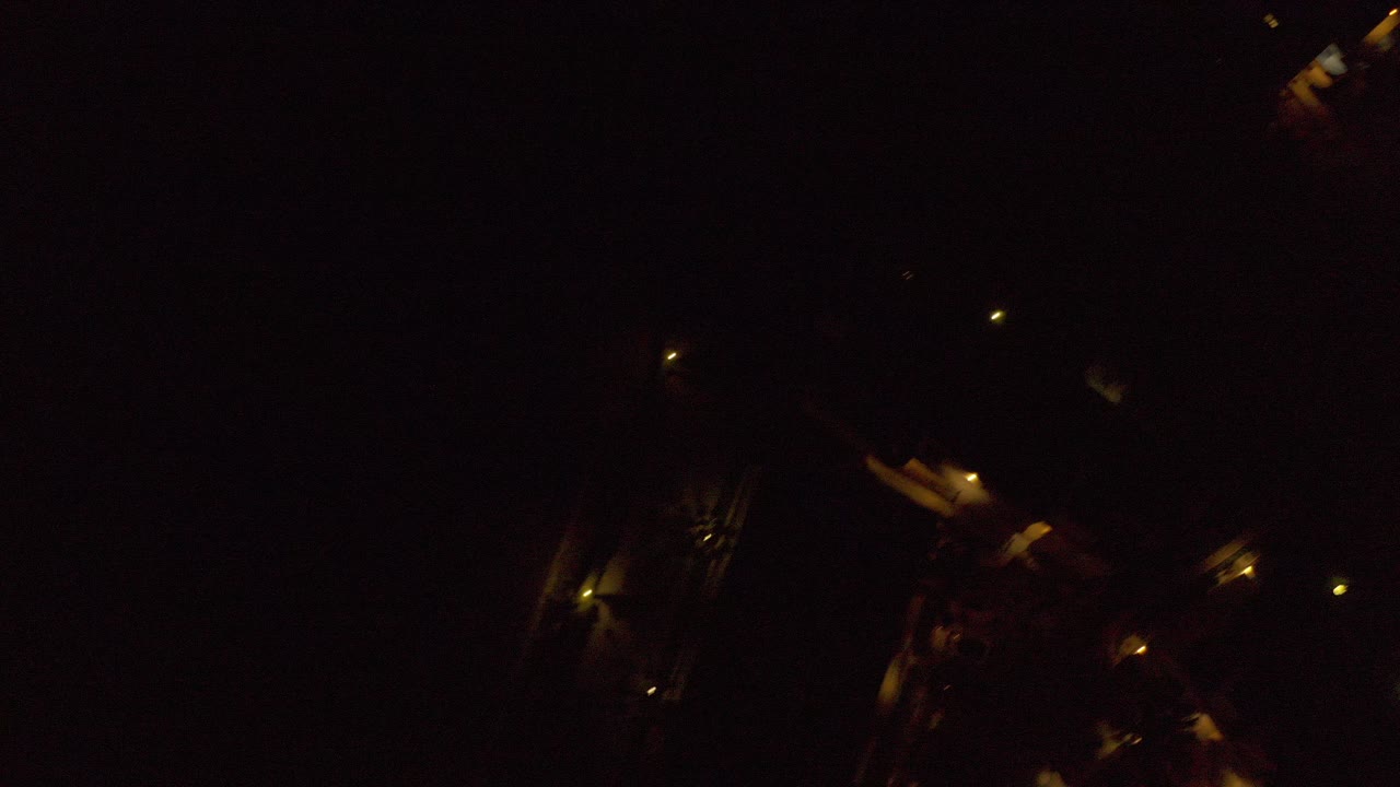 Dark overhead town view with scattered amber lights