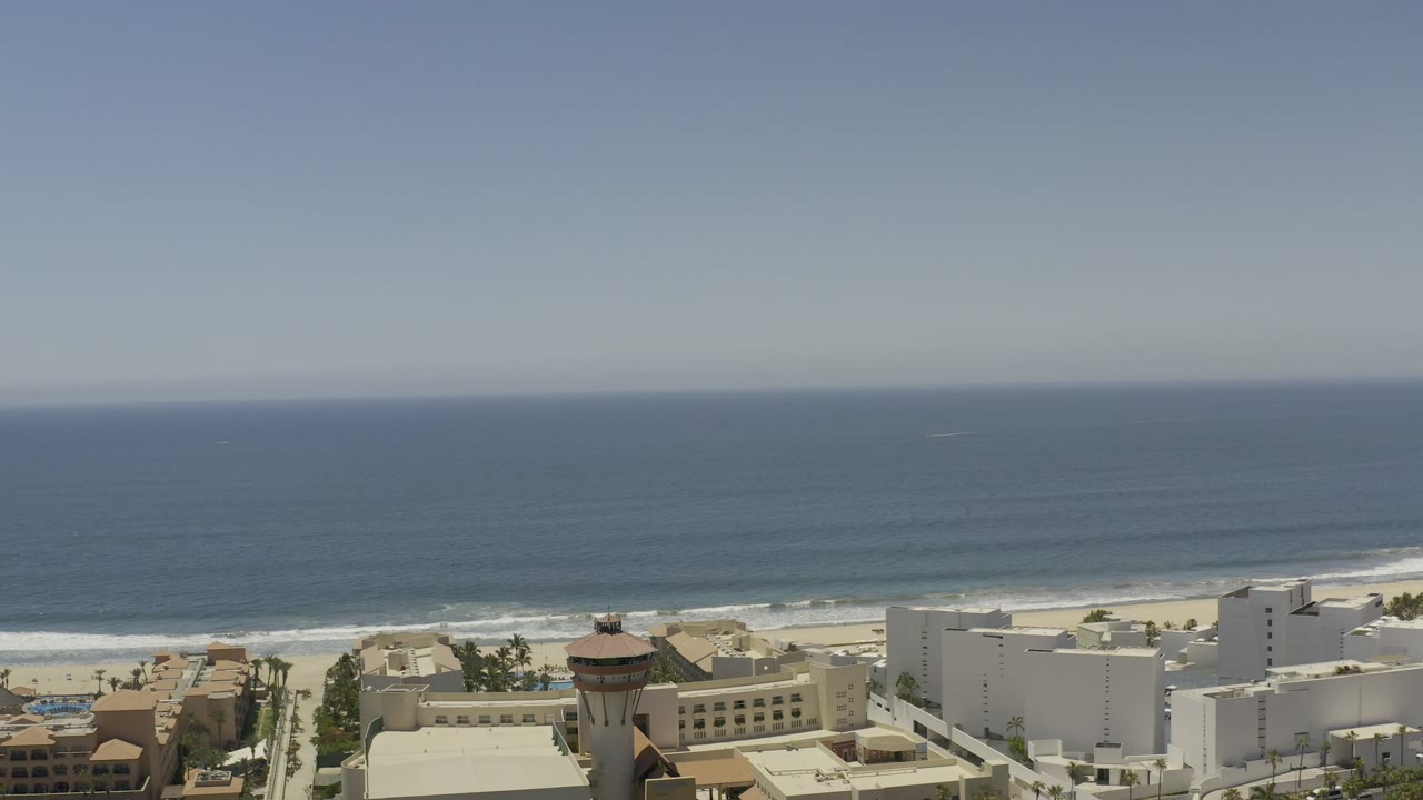 Aerial view of coastal buildings, beach, and ocean