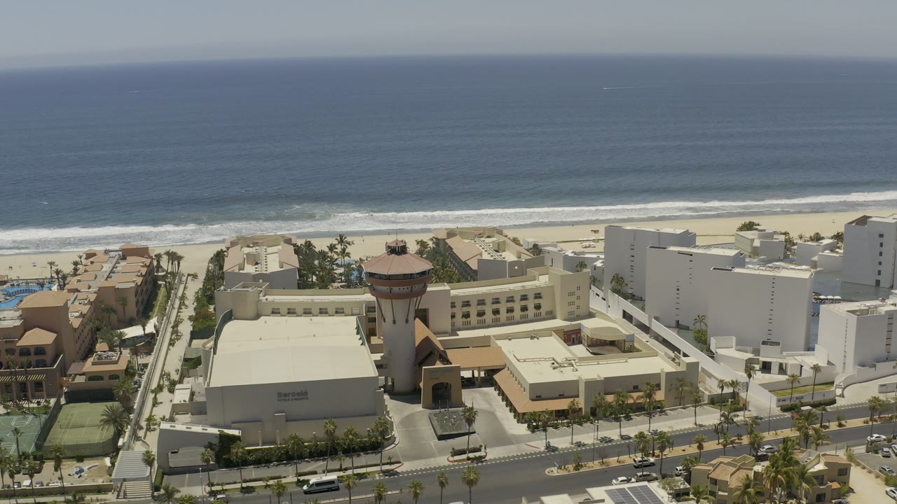 Aerial view of a beachside resort complex beside the ocean.