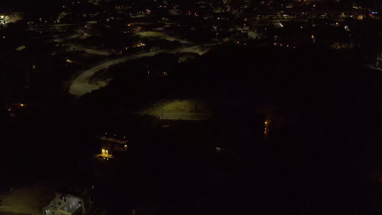 Dim aerial cityscape with olive green night lighting.