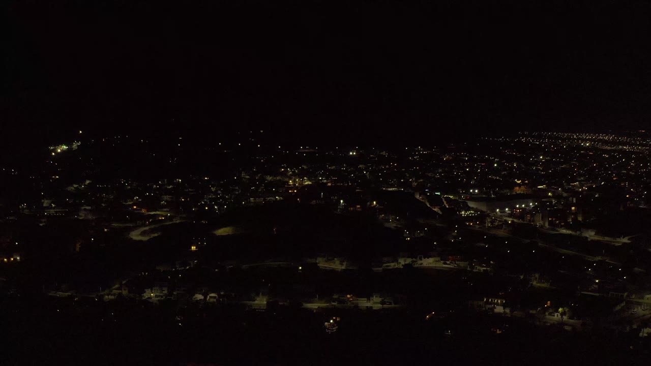 Second frame over Los Cabos shows the same nighttime street grid with a brighter concentration of lights near the center and no visible people.