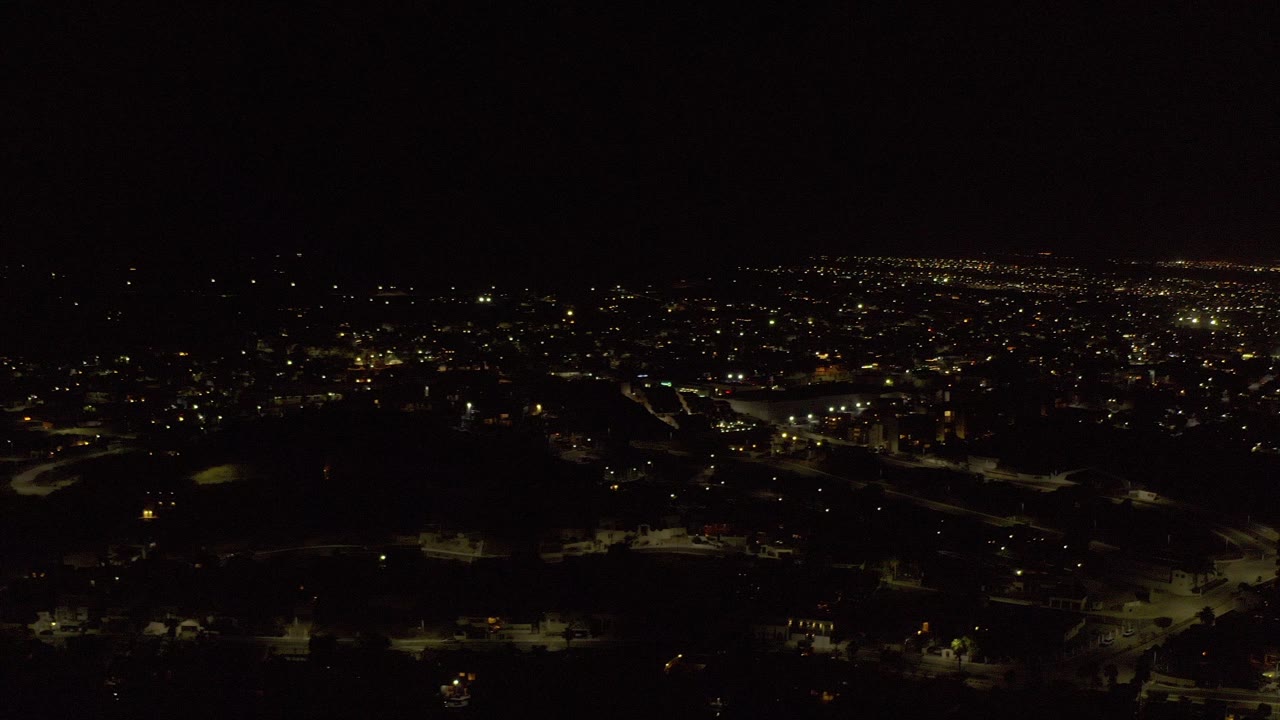 Night aerial view of houses and city lights