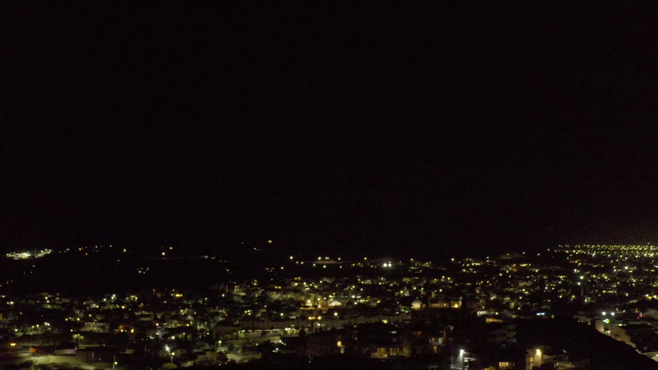 Warm city lights seen from a dark elevated viewpoint.
