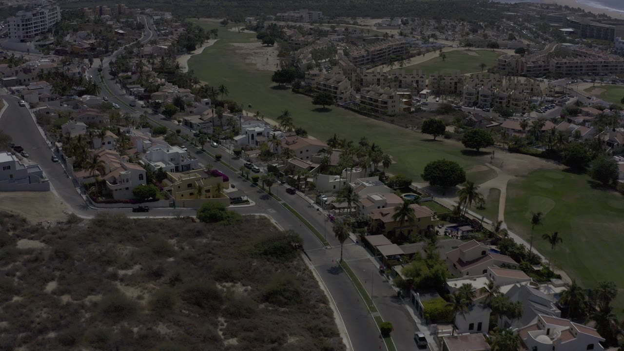 Aerial view of homes, roads, and green open space.