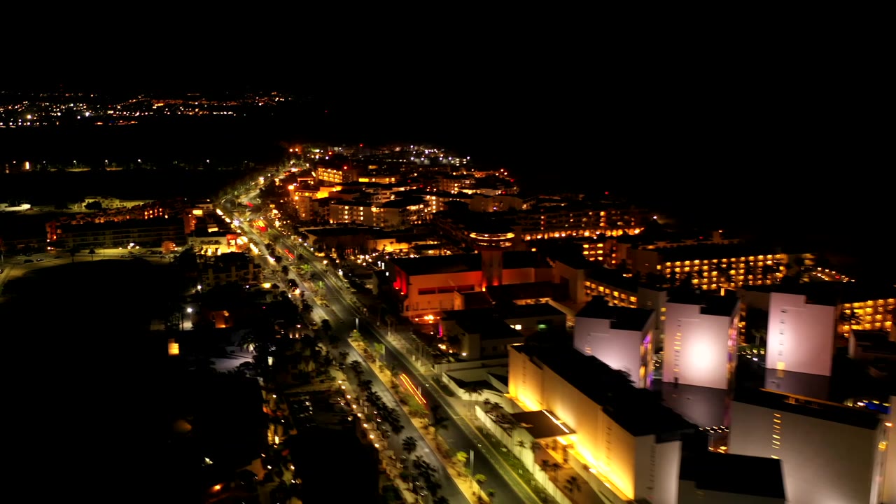 Aerial night view of traffic and hotel-like buildings