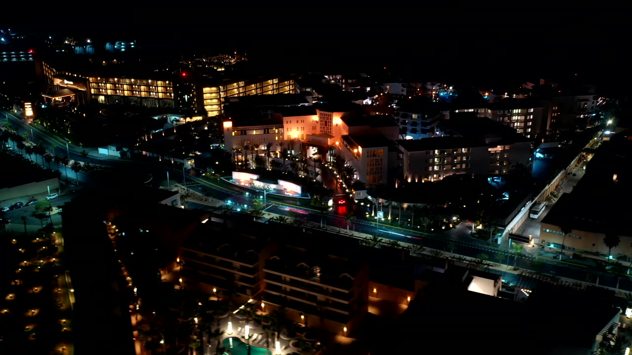 Night aerial view of lit streets and buildings.