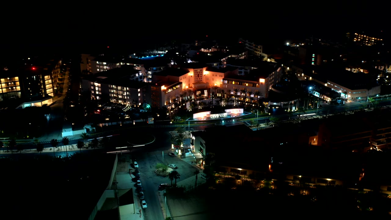 Night aerial view of lit city blocks and roads