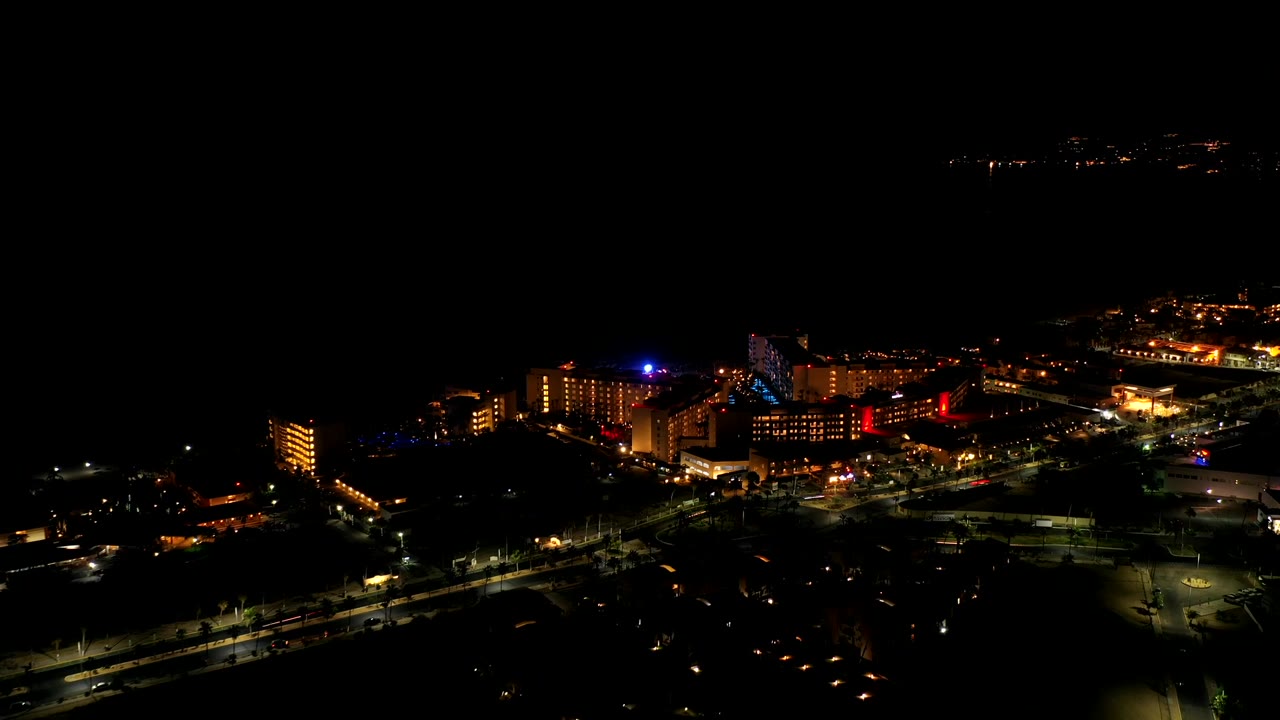 Aerial nighttime buildings with road lights