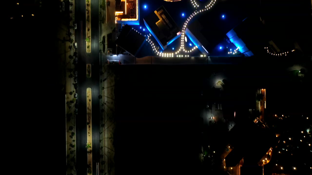 Overhead night view of lit paths and blue accent lights