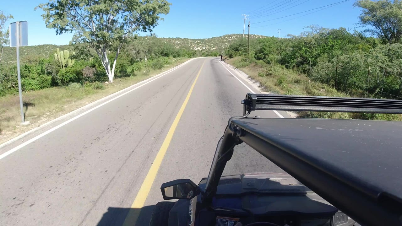 Jeep dash view passing road signs on a rural road