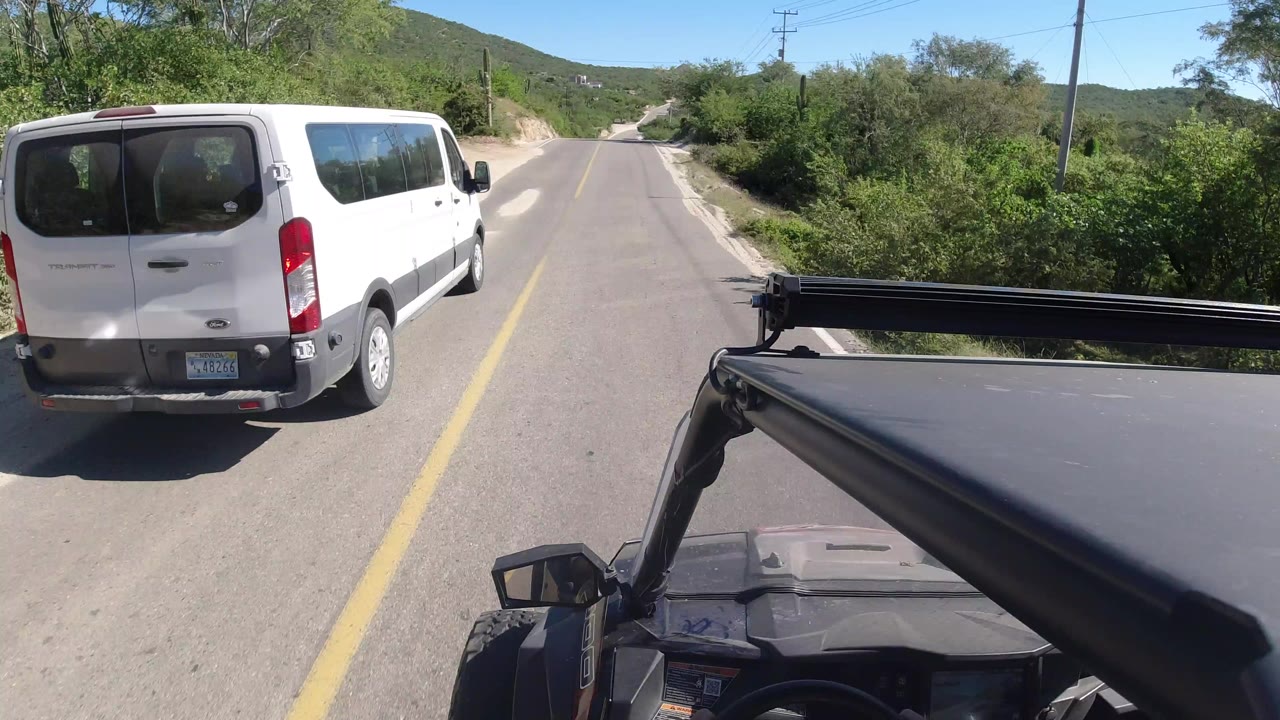 White van passing close ahead on a two-lane road