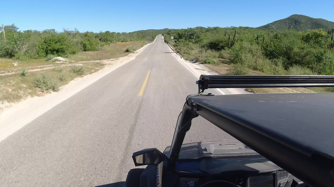 Forward view from a small SUV on a quiet two-lane highway.