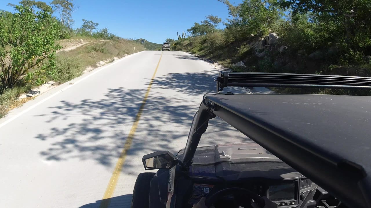 Vehicle-mounted road view passing tree shadows on pavement
