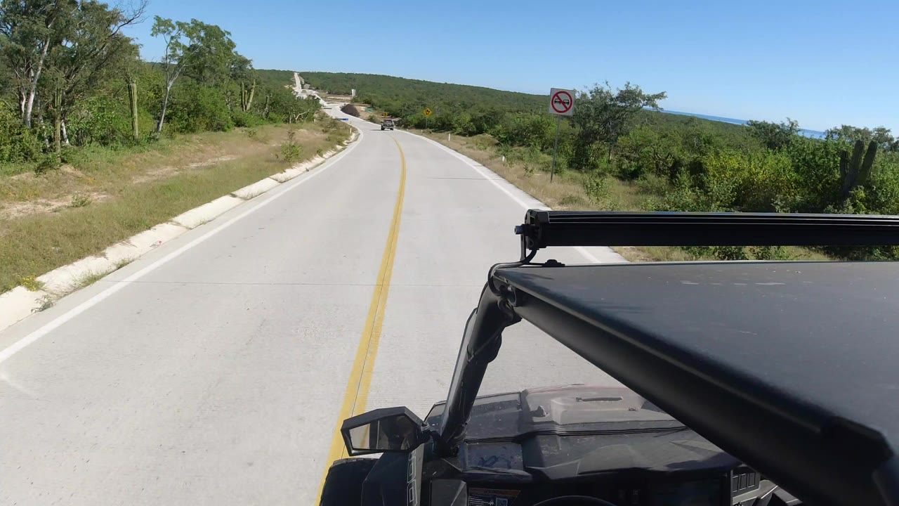 Buggy POV on a paved rural road with dry green brush.