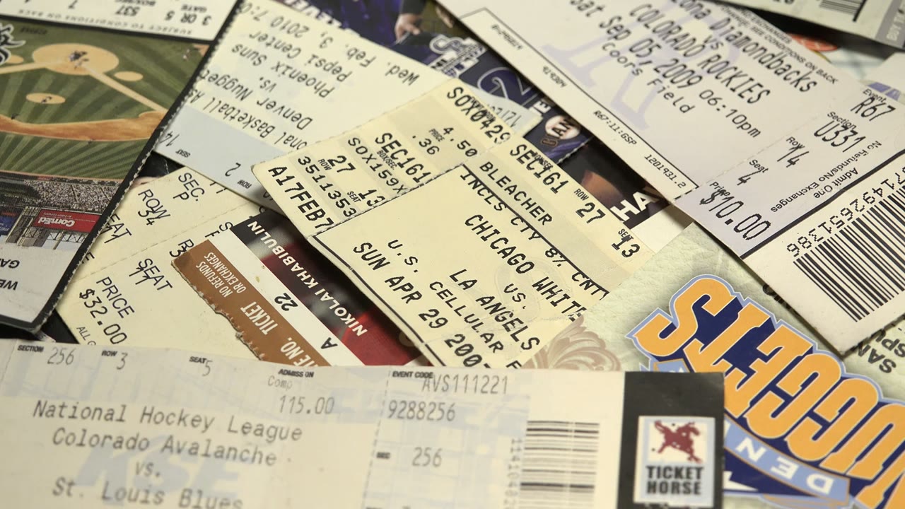 Overlapping sports tickets and stubs filling the frame.