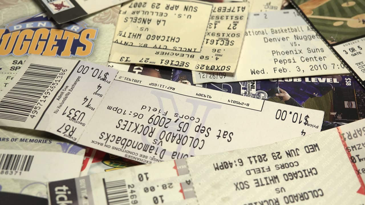 Overlapping sports tickets and receipts on a flat surface.