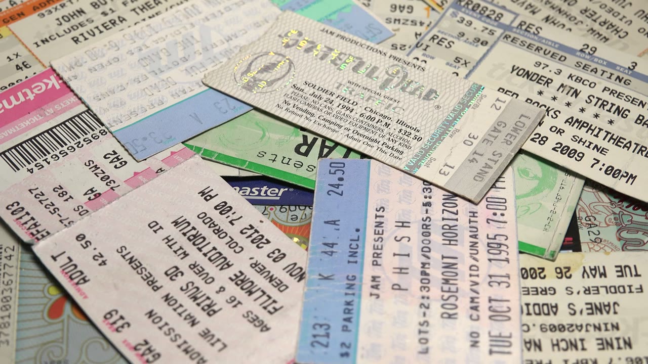 Ticket stubs with barcodes and venue text layered together.