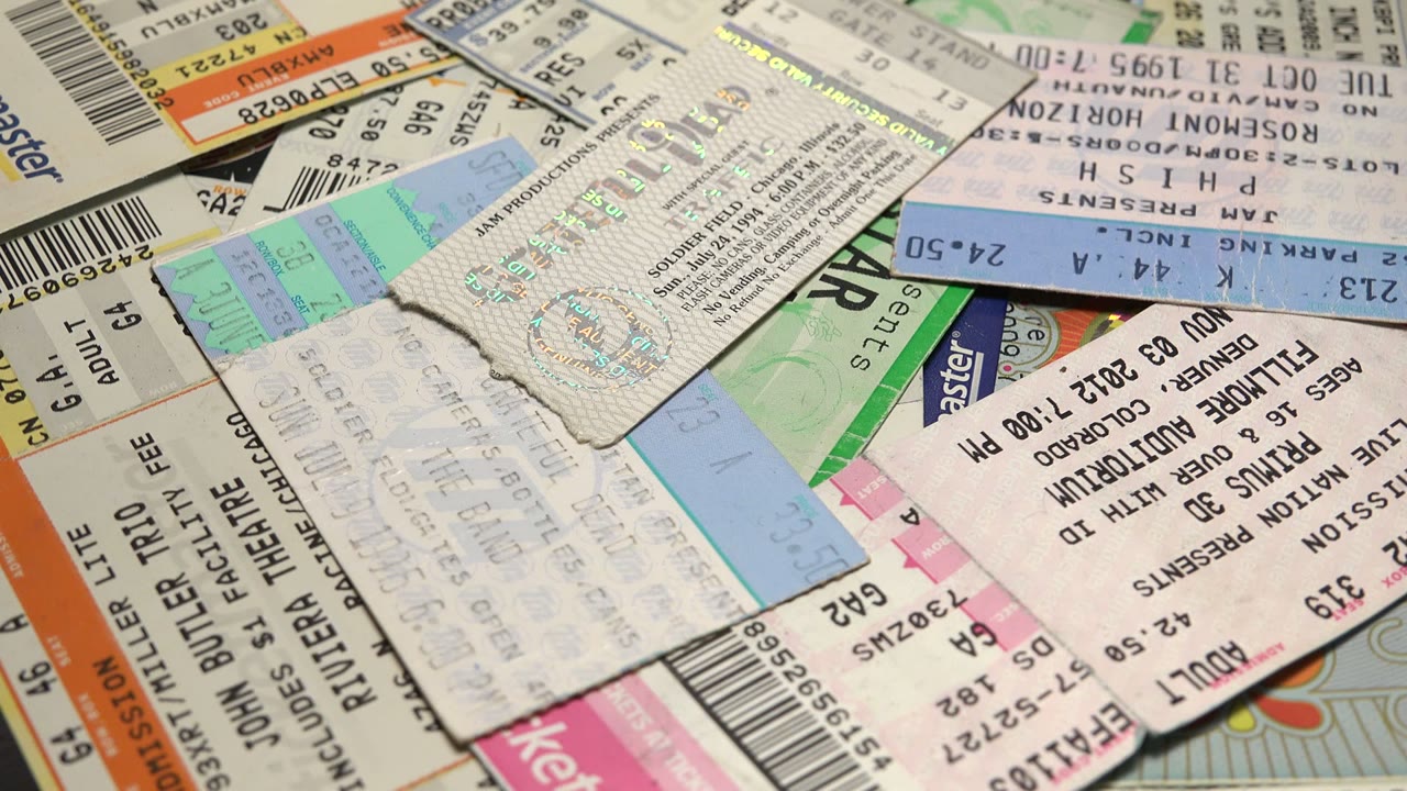 Ticket stubs overlap with printed barcodes and venue text.