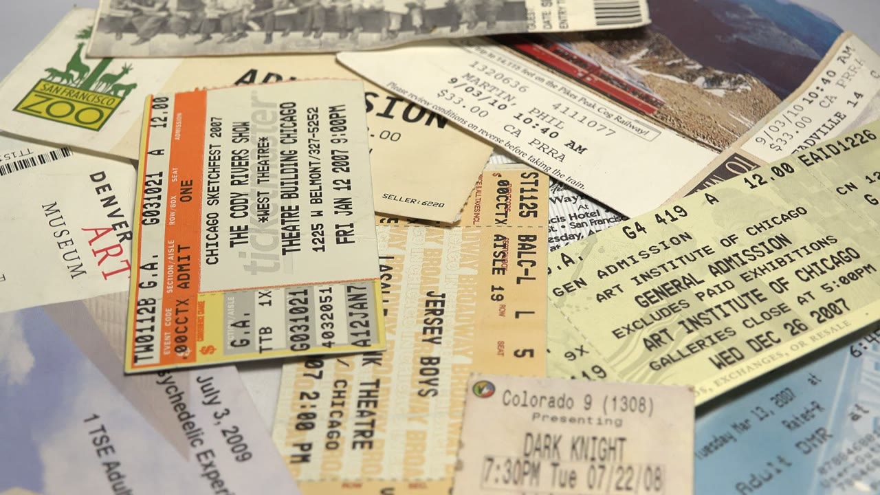 Close-up of ticket stubs with theater and museum admissions visible.