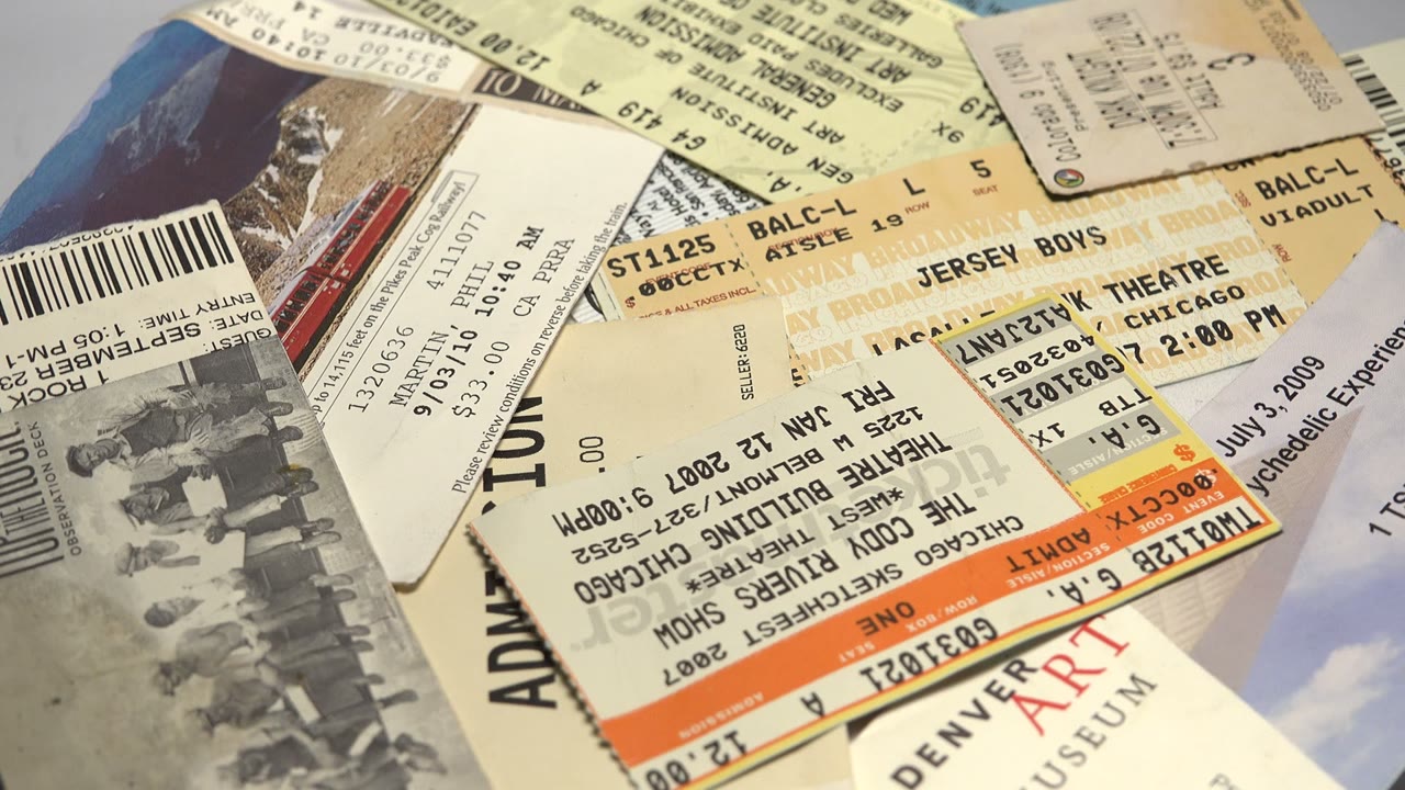Overlapping museum and theater tickets on a flat surface.
