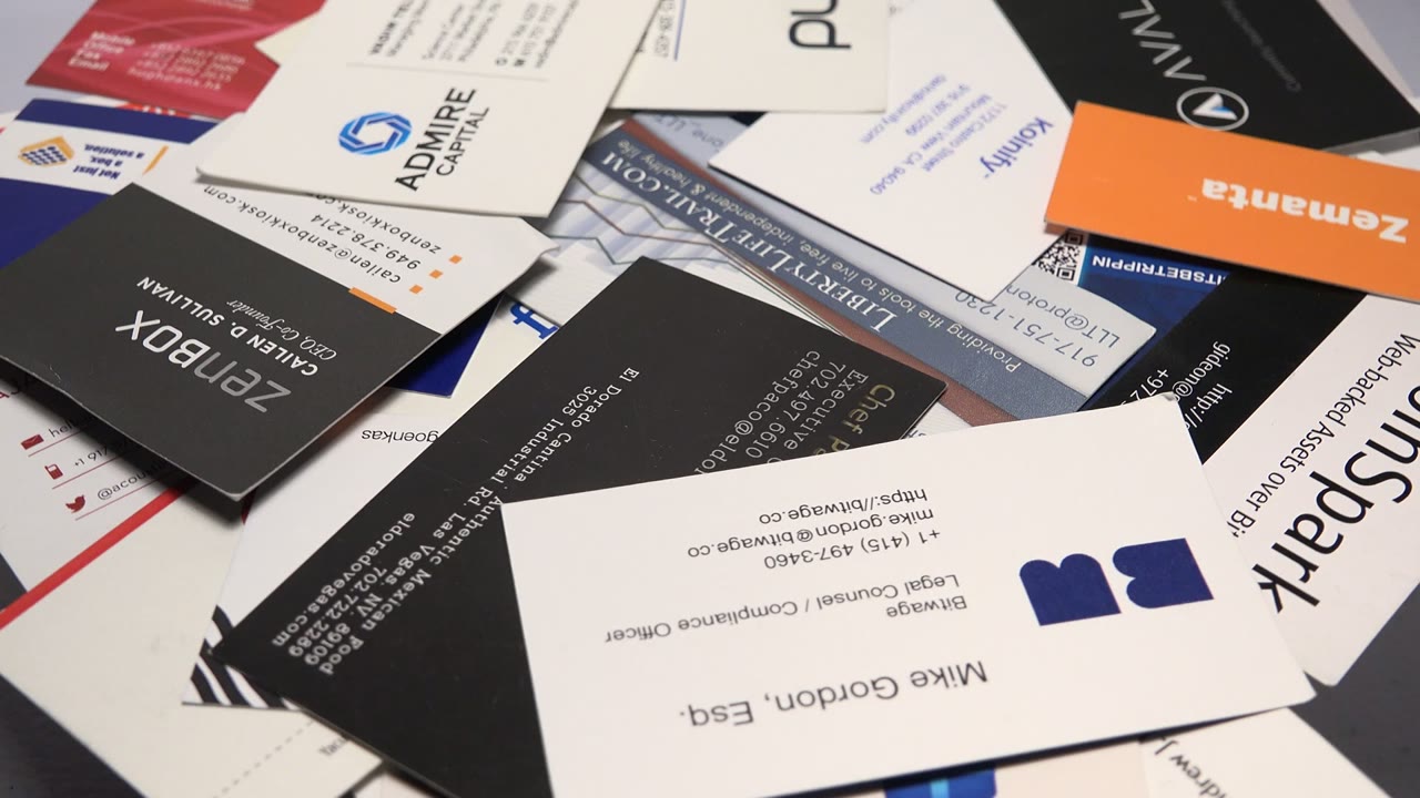 Overlapping business and promotional cards scattered across a flat surface.