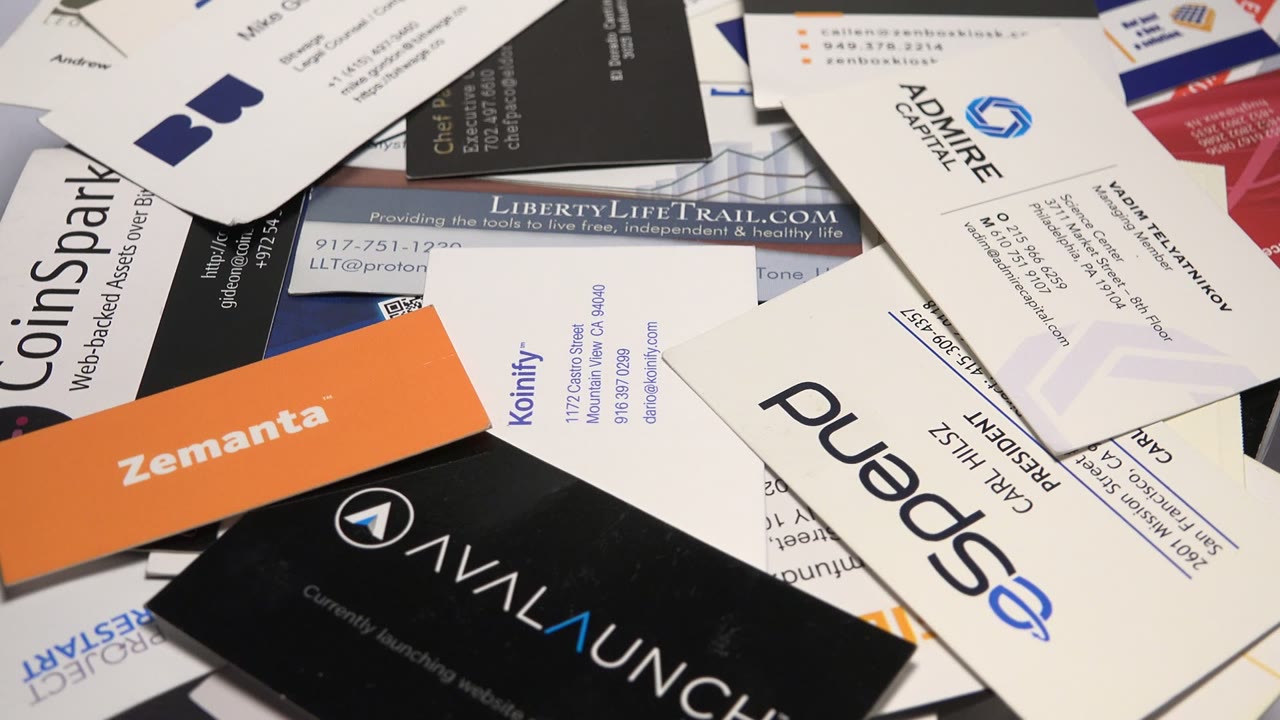 Overlapping business cards with Zemanta, AnyLaunch, and eSpend cards visible