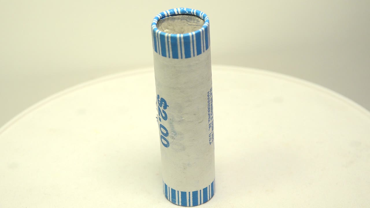 Close view of a $2.00 nickel roll on a white circular board.