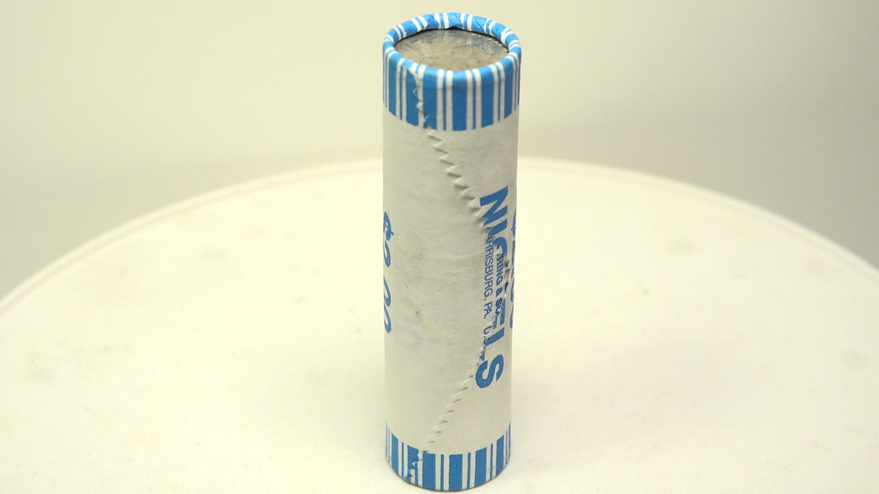 Close view of a rotating wrapped roll of nickels.