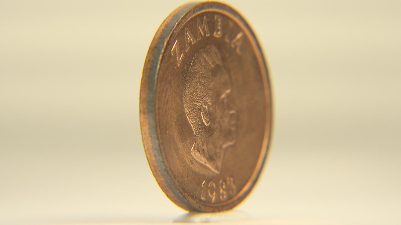 Coin angled to show a portrait side and rim.