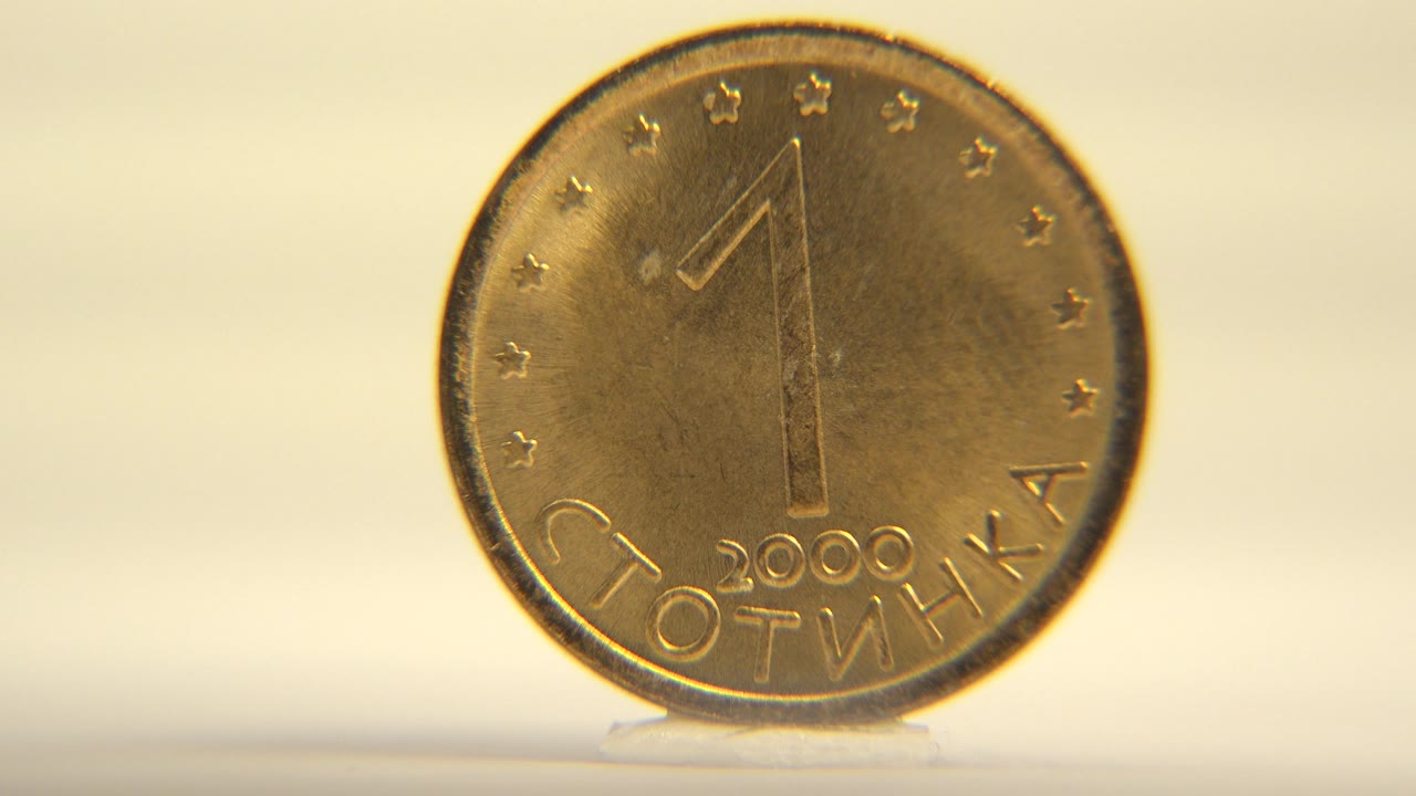 Close frontal view of a coin with a large number one.
