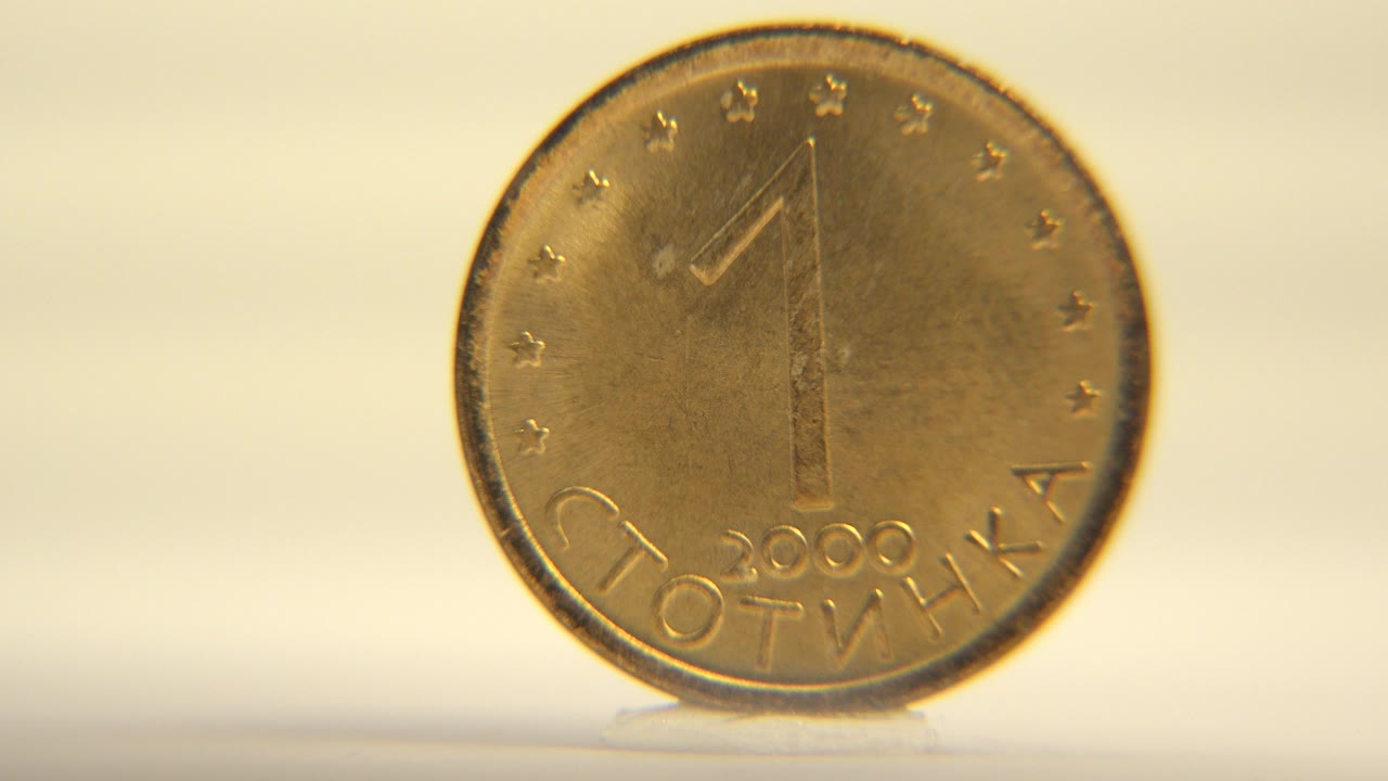Upright coin facing camera under warm light