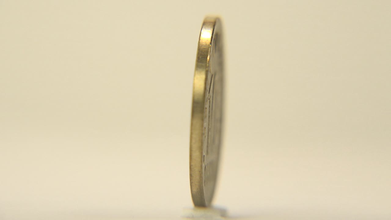 Coin appears as a vertical edge near the left side of frame.