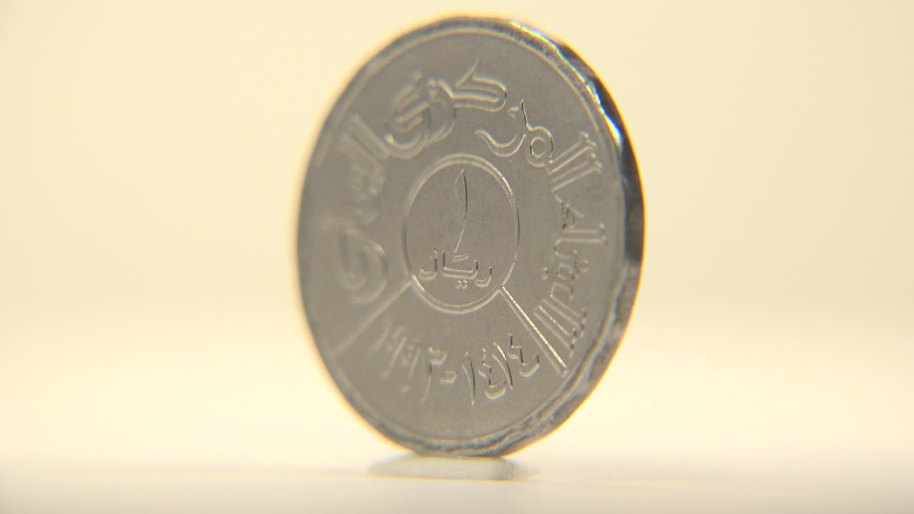 Bright coin face on a pale tabletop.